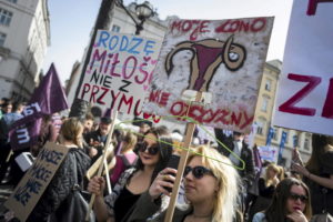 People demonstrate against the Polish government's plan to tightening the abortion law in Krakow, Poland April 3, 2016. The signs read: "I'm giving birth from love not from being forced" and "My womb does not belong to homeland" (R). REUTERS/Lukasz Kaminski/Agencja Gazeta ATTENTION EDITORS - THIS IMAGE HAS BEEN SUPPLIED BY A THIRD PARTY. IT IS DISTRIBUTED EXACTLY AS RECEIVED BY REUTERS, AS A SERVICE TO CLIENTS. POLAND OUT. NO COMMERCIAL SALES IN POLAND. - RTSDEAH